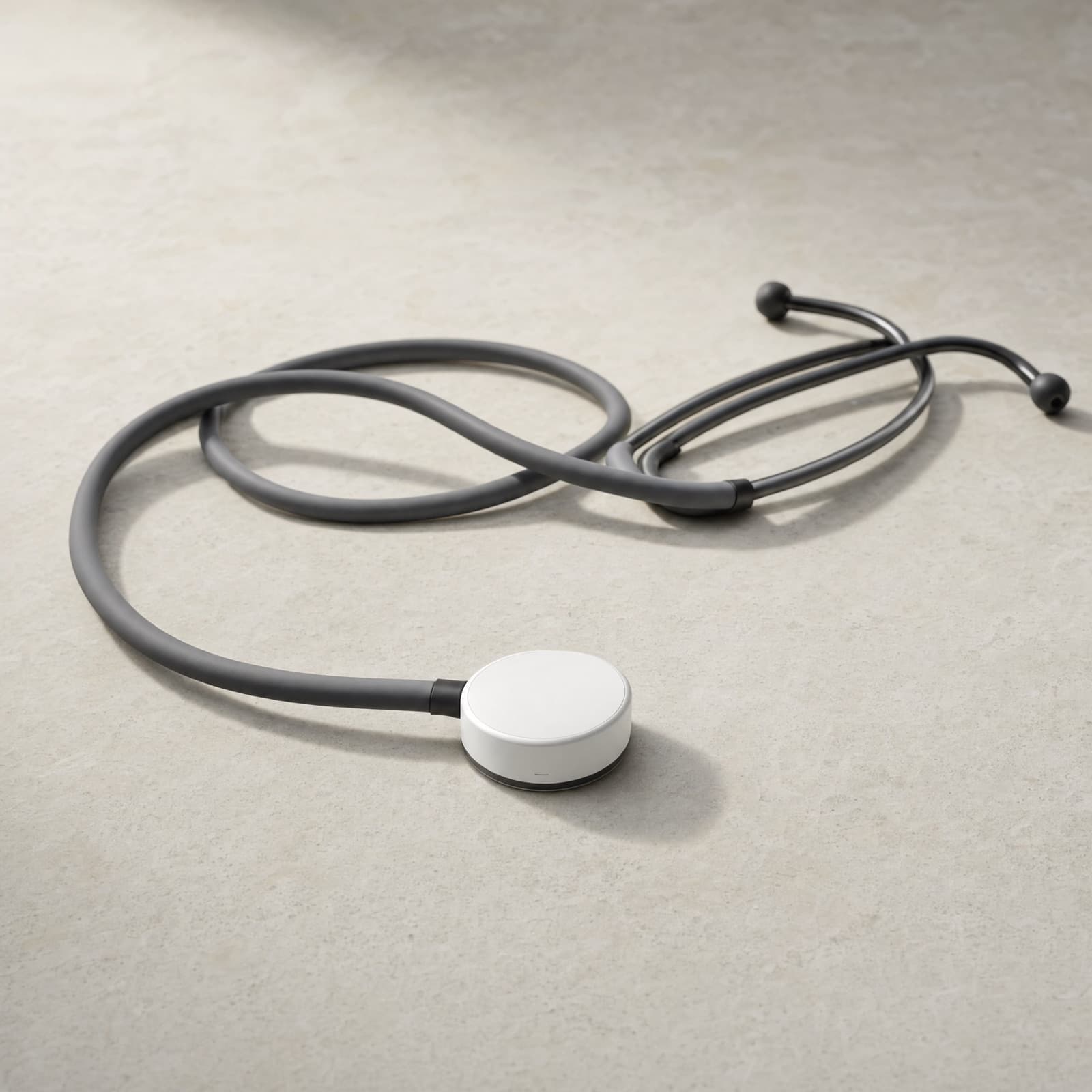 A digital stethoscope lying on a stone surface
